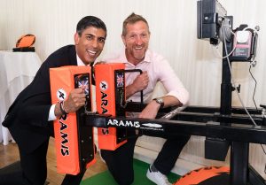 Chancellor of the Exchequer Rishi Sunak attempts to push the Aramis digital scrum machine with Former England rugby star Will Greenwood